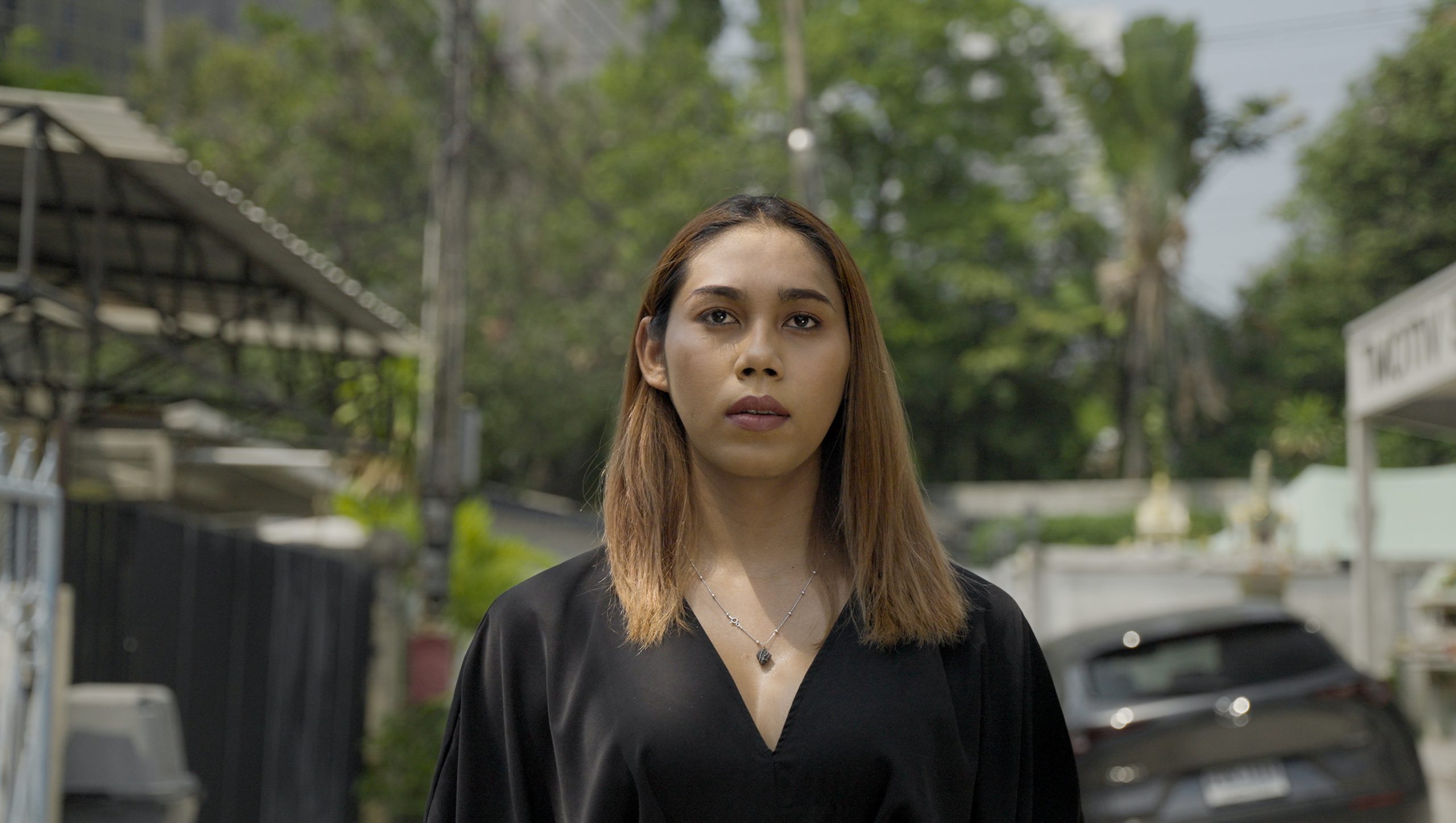 A transgender woman activist looks towards the camera.