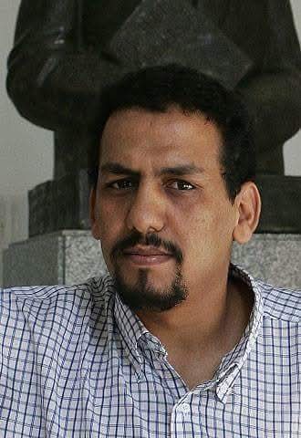 Photo of Ali Salem Tamek, looking towards the camera.